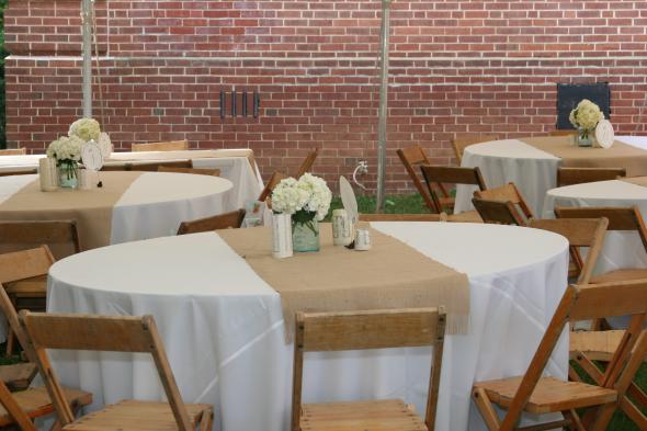 The tables will have ivory linens with burlap table runners
